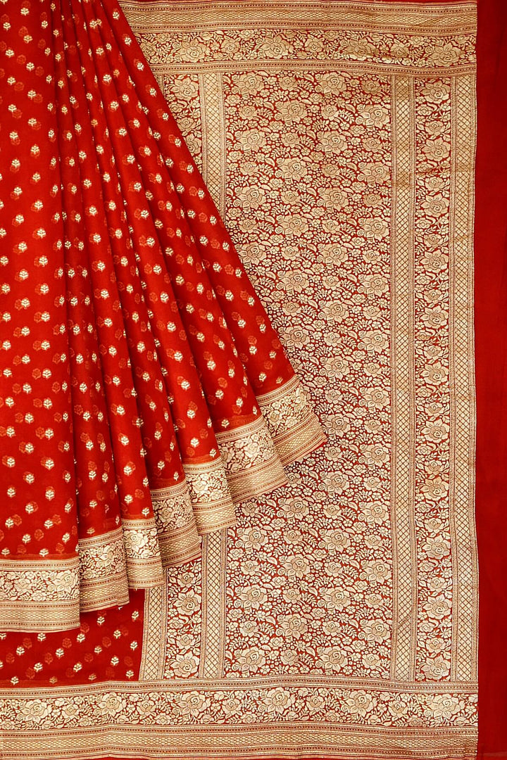 Banarasi silk georgette saree  in red with small motifs all over the body.