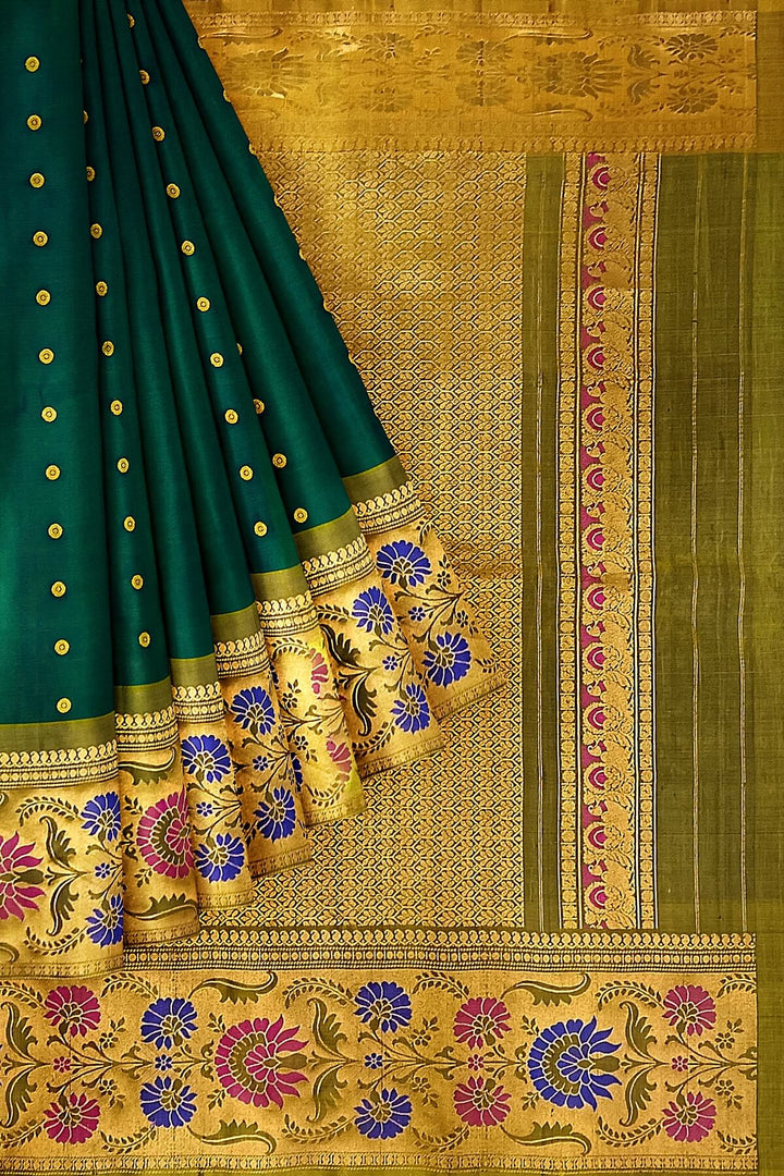 Handwoven Gadwal pure silk saree in bottle green with gold  motifs  all over the body.