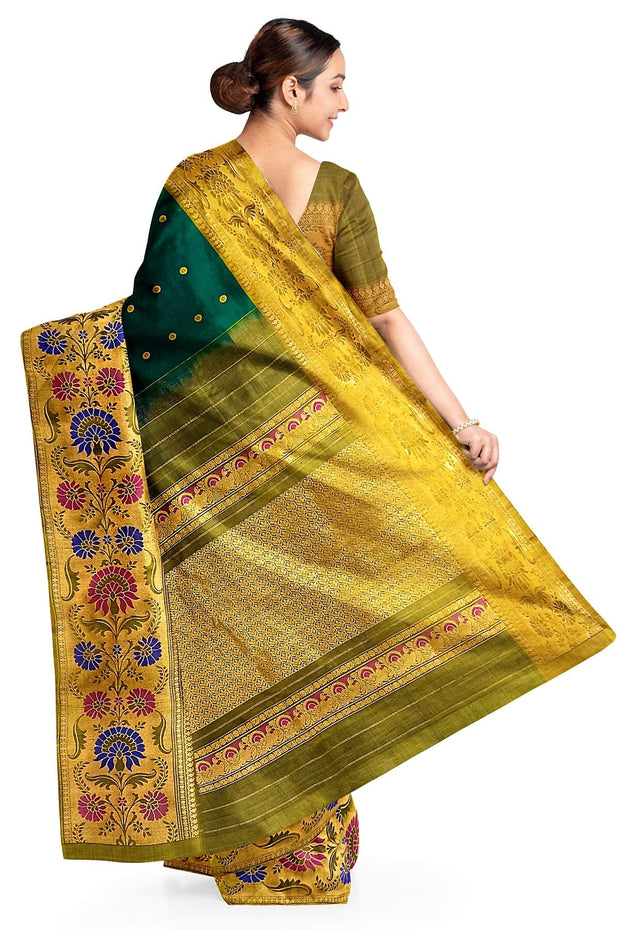 Handwoven Gadwal pure silk saree in bottle green with gold  motifs  all over the body.