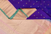 Handwoven Gadwal pure silk saree in purple with floral and paisley  motifs in gold & silver.