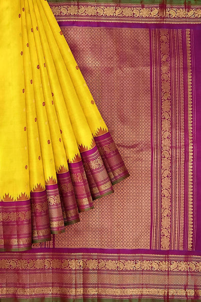Handwoven Gadwal pure silk saree in yellow with floral   motifs in gold & magenta.
