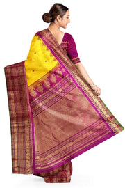 Handwoven Gadwal pure silk saree in yellow with floral   motifs in gold & magenta.