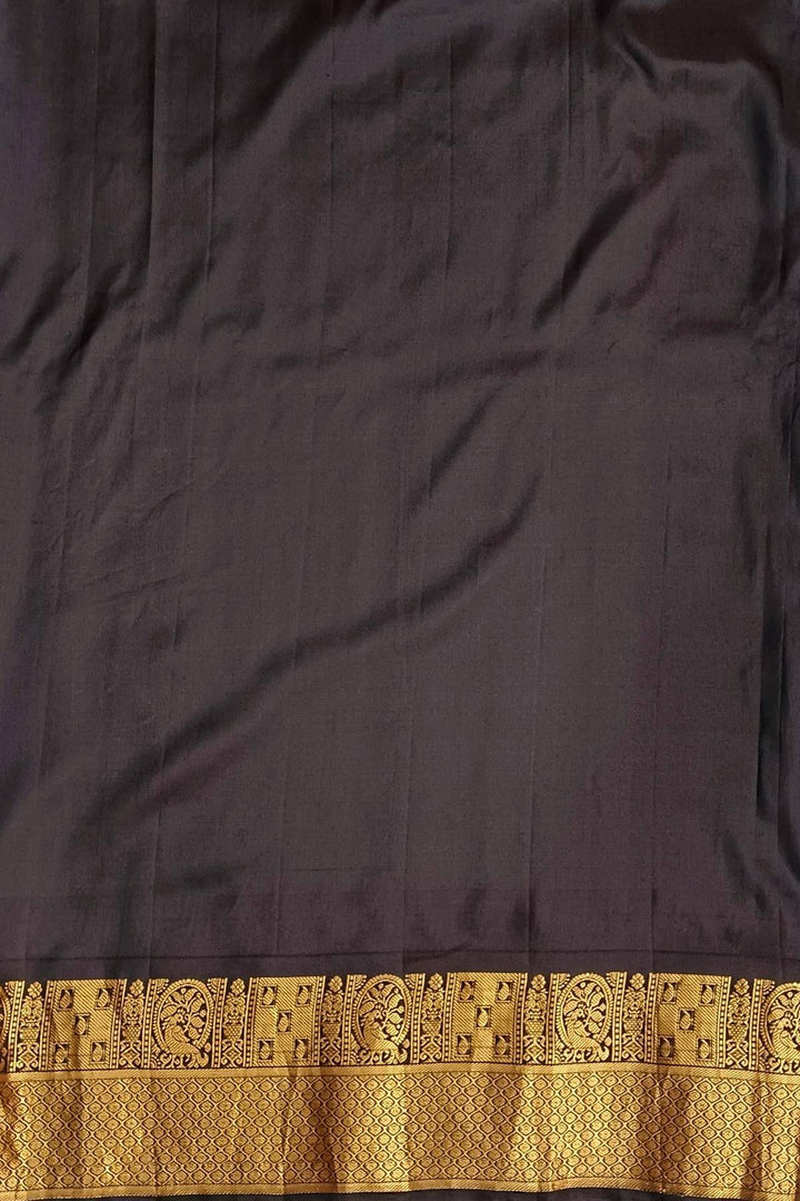 Gadwal pure silk saree in copper sulphate blue with  peacock &  disc  motif in gold.