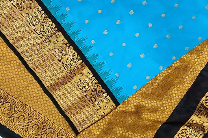 Gadwal pure silk saree in copper sulphate blue with  peacock &  disc  motif in gold.