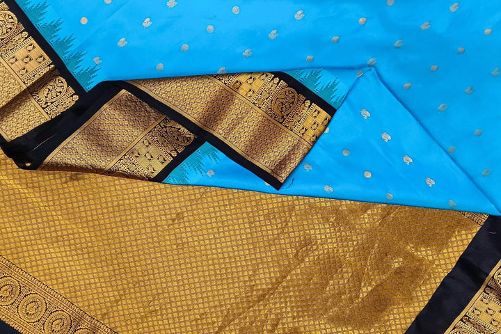 Gadwal pure silk saree in copper sulphate blue with  peacock &  disc  motif in gold.