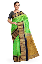 Gadwal pure silk saree in green with  peacock &  disc  motif in gold.