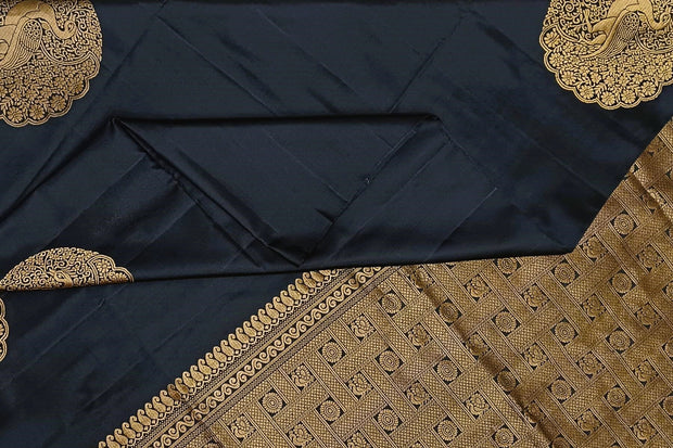 Kanchi soft silk saree in black with peacock motifs in gold