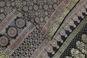 Modal silk saree in black  in hand block ajrakh print with zari border.