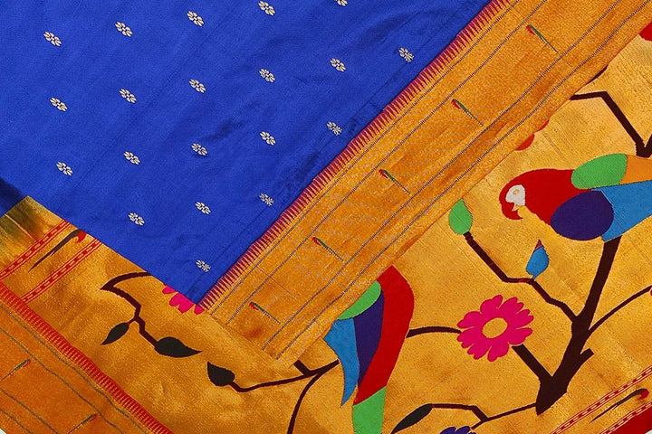 Paithani pure silk saree in royal blue with small floral motifs  on the body .