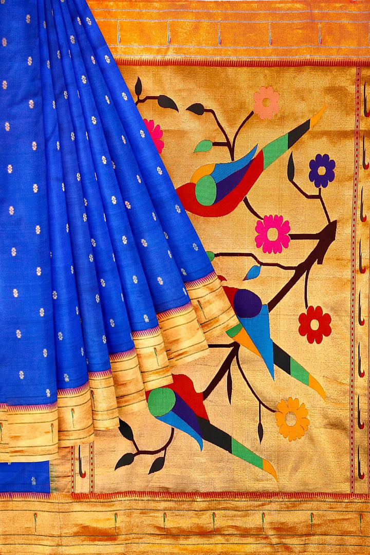 Paithani pure silk saree in royal blue with small floral motifs  on the body .