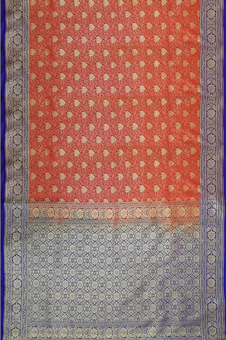 Handloom Banarasi silk saree in satin weave in red with floral motifs all over the body.