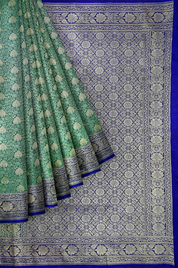 Handloom Banarasi silk saree in satin weave in red with floral motifs all over the body.