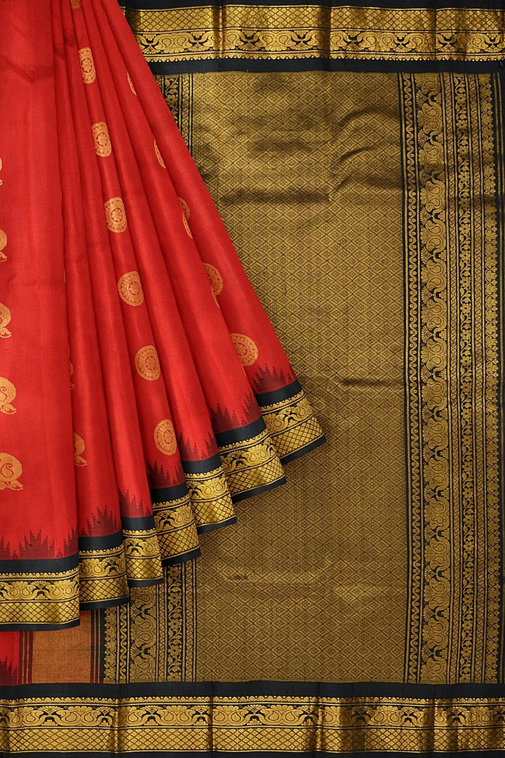 Handwoven Gadwal pure silk saree in red with disc & floral motifs and rich pallu with temple border