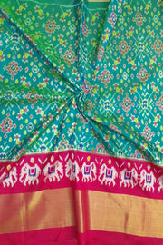 Handwoven Ikat pure silk unstitched lehenga material in teal green & pink in navratan pattern