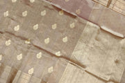 Snuff silk tissue handloom Banarasi saree with floral motifs in gold.