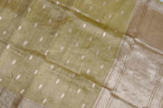 Green silk tissue handloom Banarasi saree with floral motifs in gold.