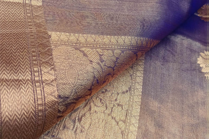 Violet silk tissue handloom Banarasi saree with floral motifs in gold.