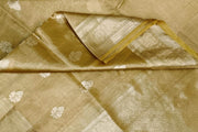 Yellow silk tissue handloom Banarasi saree with floral motifs in gold.