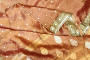Handloom Banarasi silk tissue saree in rust with floral motifs