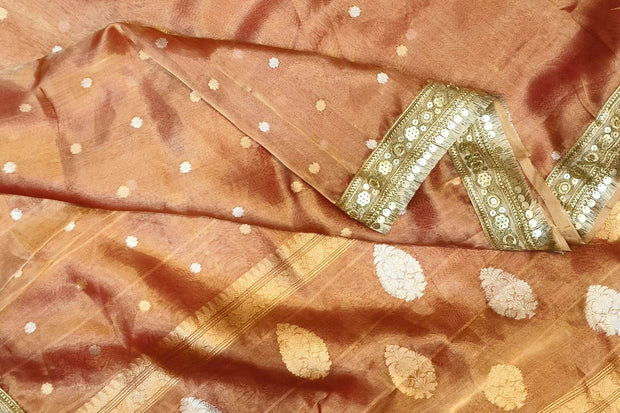 Handloom Banarasi silk tissue saree in rust with floral motifs