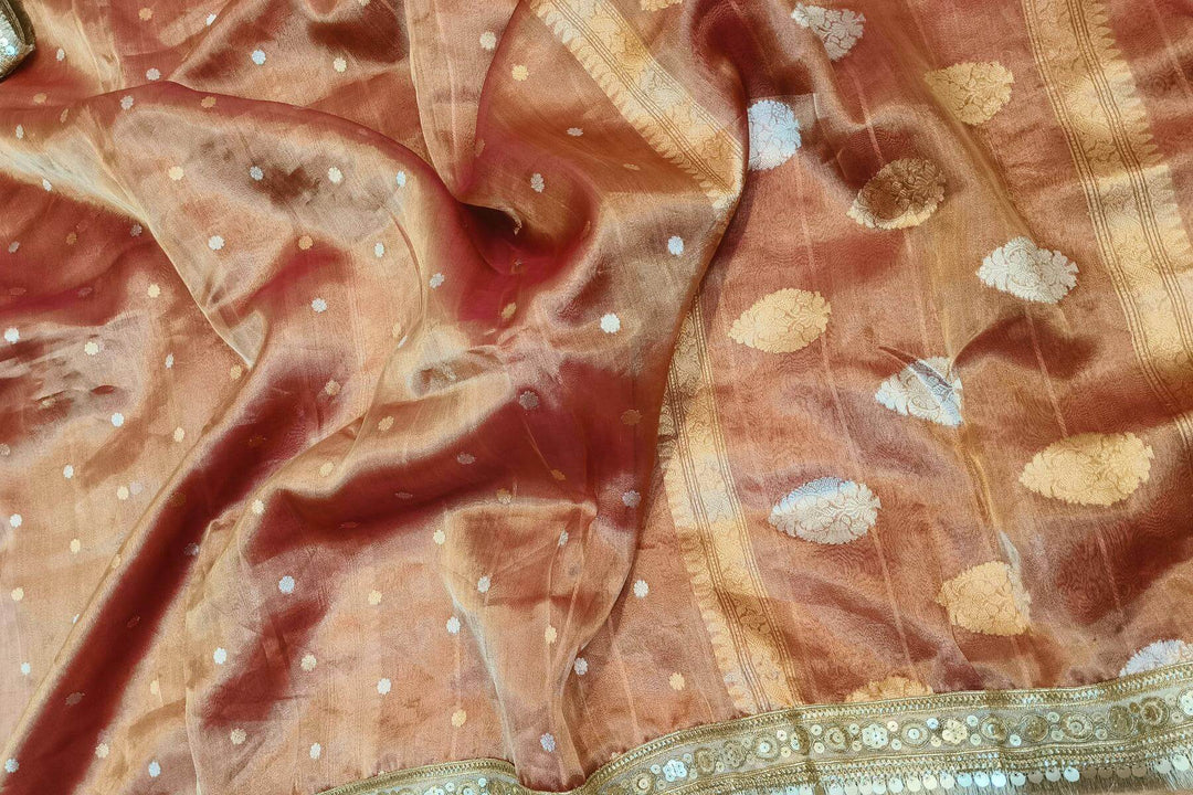 Handloom Banarasi silk tissue saree in rust with floral motifs