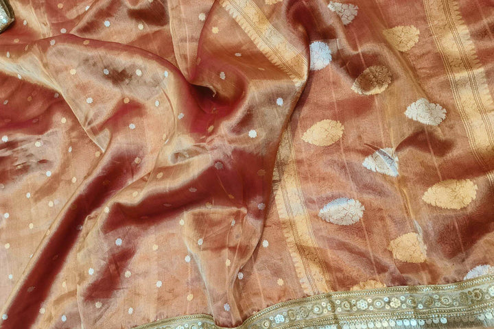 Handloom Banarasi silk tissue saree in rust with floral motifs