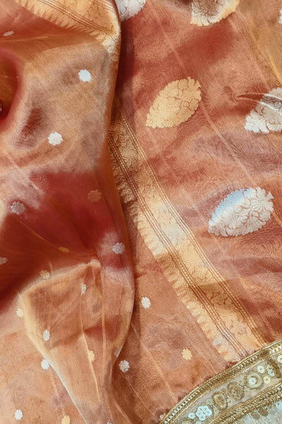 Handloom Banarasi silk tissue saree in rust with floral motifs