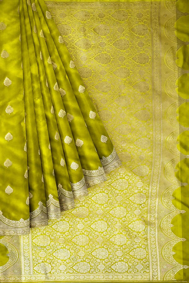 Banarasi mashru silk saree in  radium green  with floral motifs