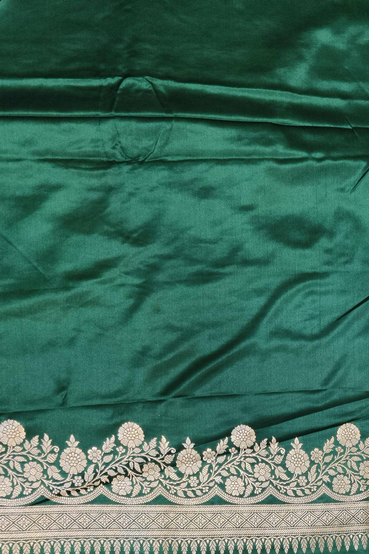 Banarasi mashru silk saree in  bottle  green  with floral motifs