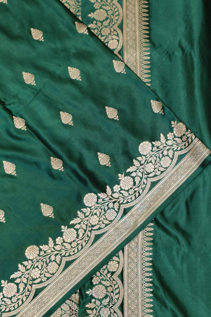 Banarasi mashru silk saree in  bottle  green  with floral motifs
