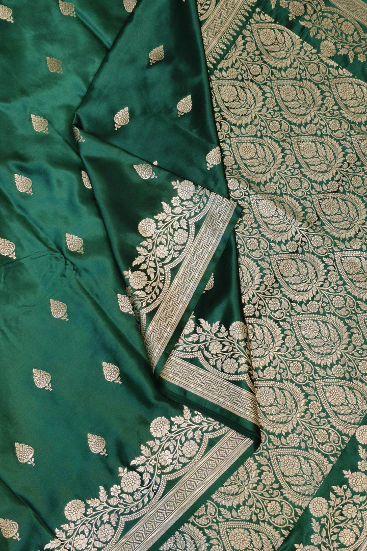 Banarasi mashru silk saree in  bottle  green  with floral motifs