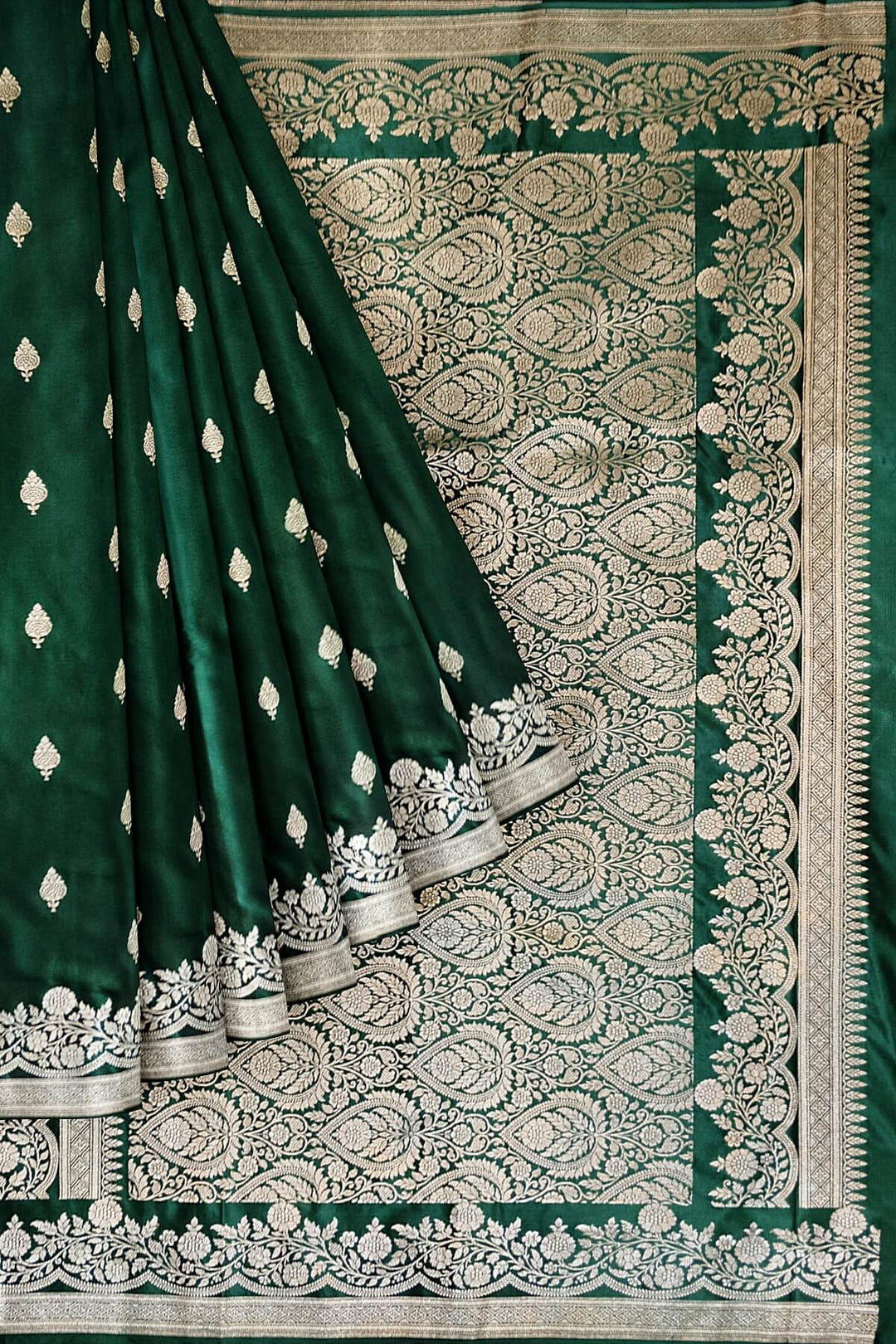 Banarasi mashru silk saree in  bottle  green  with floral motifs