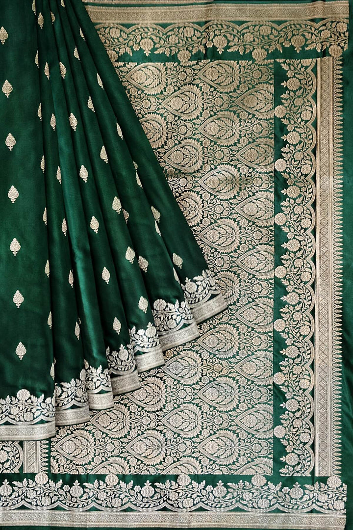 Banarasi mashru silk saree in  bottle  green  with floral motifs