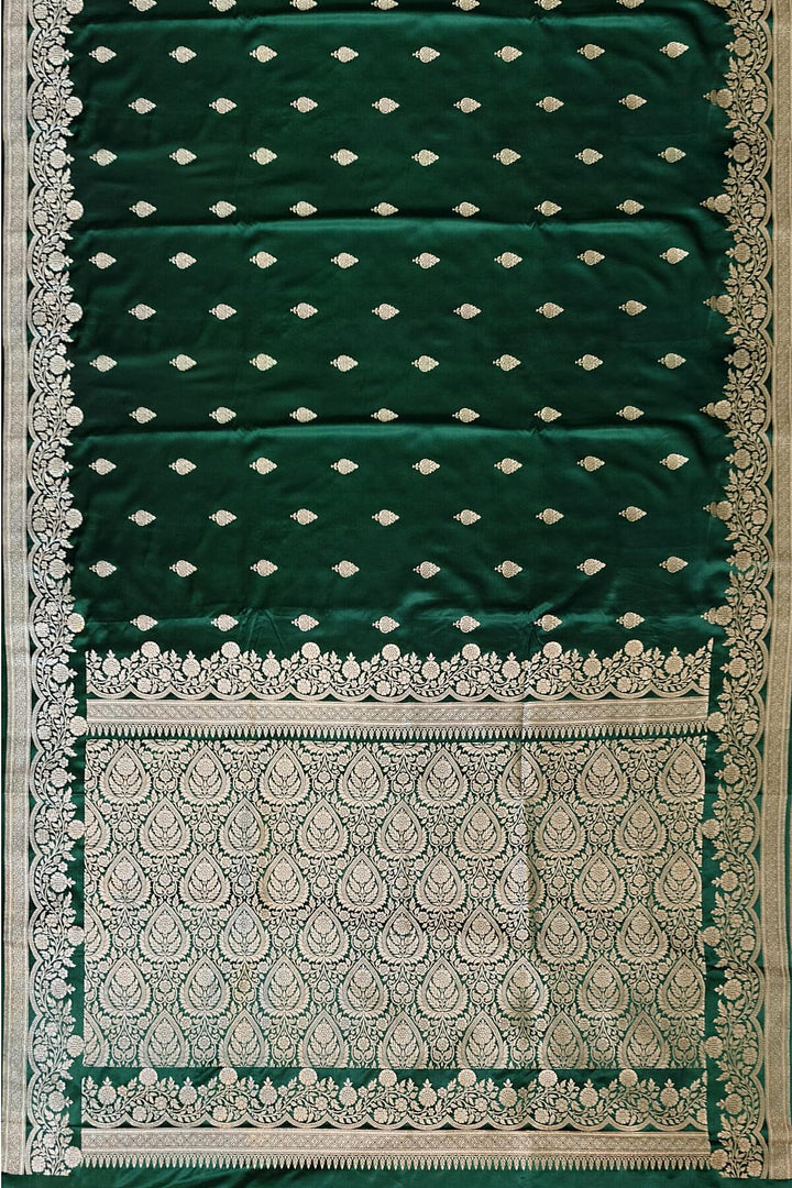 Banarasi mashru silk saree in  bottle  green  with floral motifs