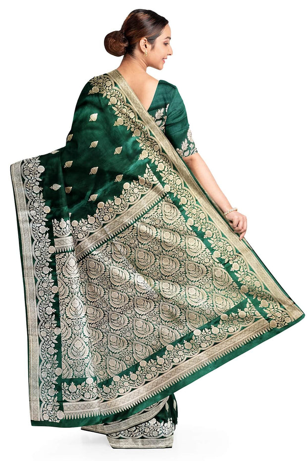 Banarasi mashru silk saree in  bottle  green  with floral motifs