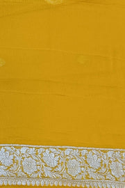 Banarasi silk chiffon  saree in yellow  with silver  buttis &  border