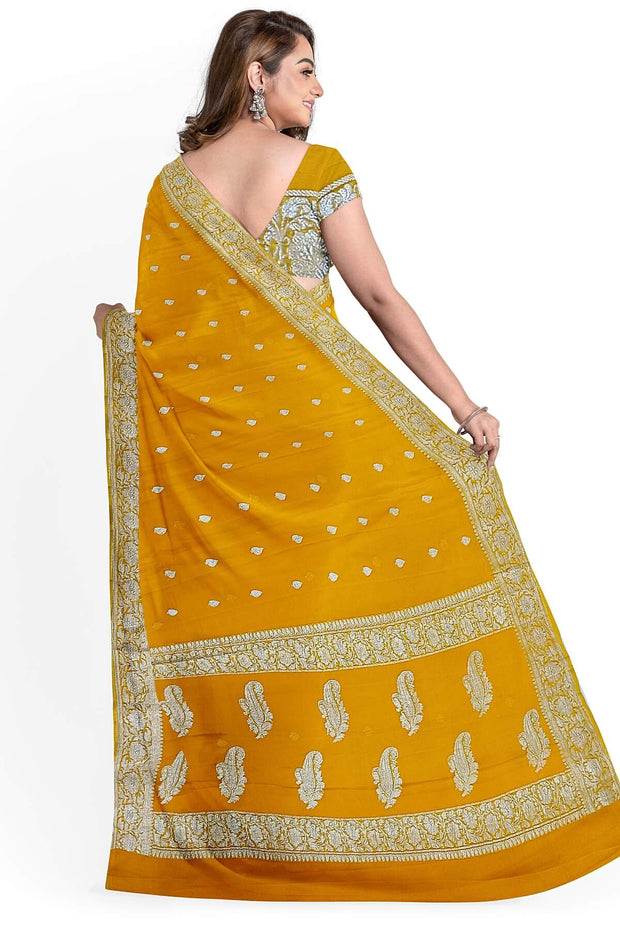 Banarasi silk chiffon  saree in yellow  with silver  buttis &  border