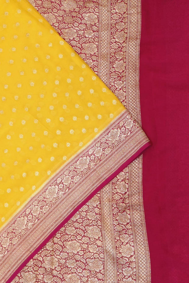 Banarasi silk georgette saree  in yellow with small motifs all over the body.