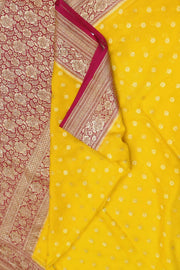 Banarasi silk georgette saree  in yellow with small motifs all over the body.