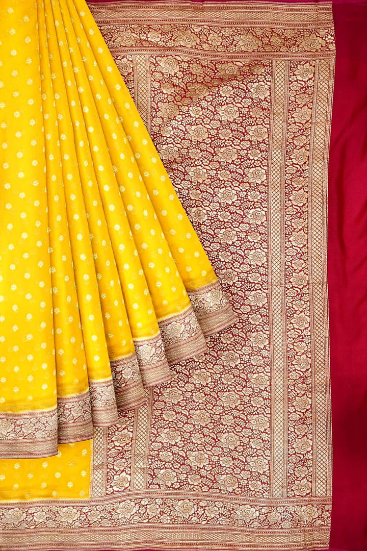 Banarasi silk georgette saree  in yellow with small motifs all over the body.