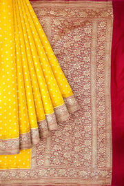 Banarasi silk georgette saree  in yellow with small motifs all over the body.