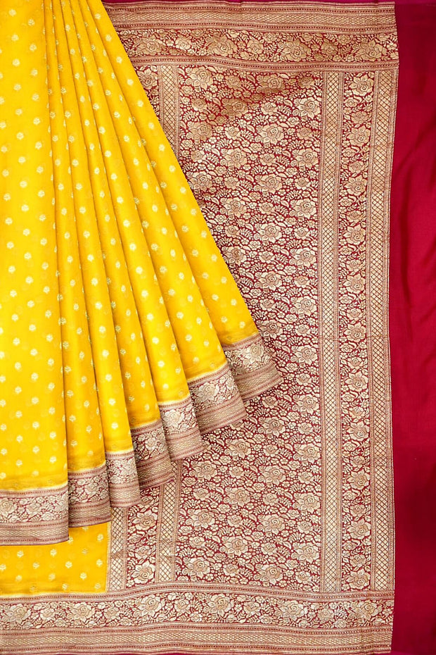 Banarasi silk georgette saree  in yellow with small motifs all over the body.