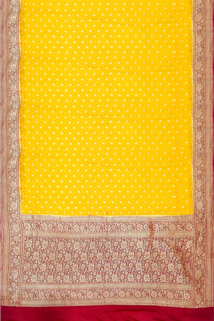 Banarasi silk georgette saree  in yellow with small motifs all over the body.