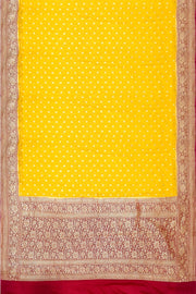 Banarasi silk georgette saree  in yellow with small motifs all over the body.