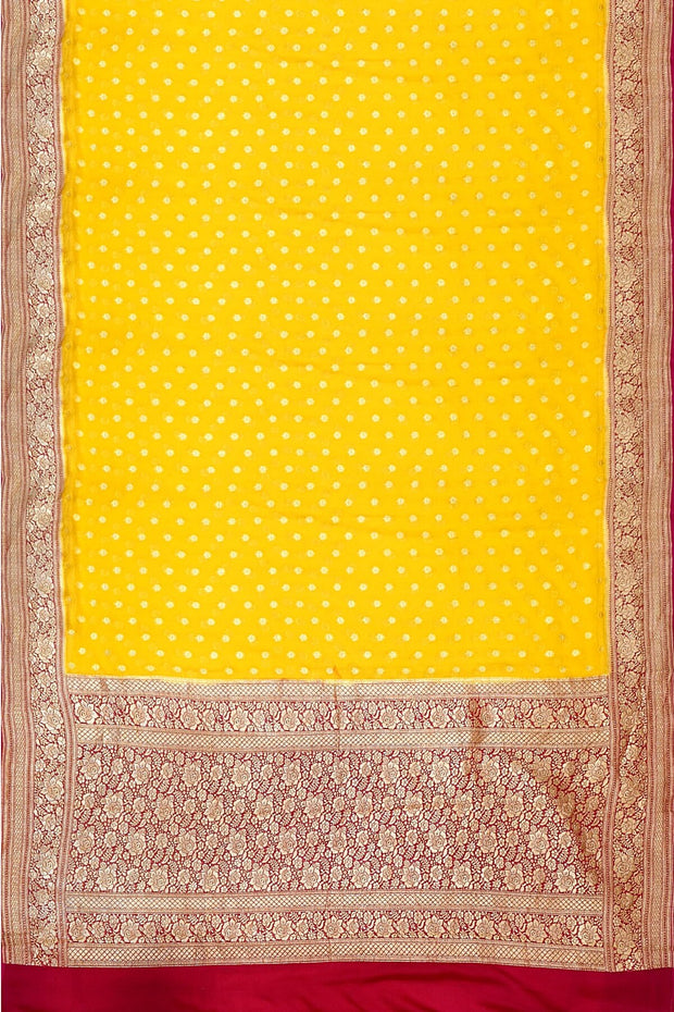 Banarasi silk georgette saree  in yellow with small motifs all over the body.