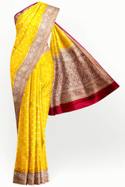 Banarasi silk georgette saree  in yellow with small motifs all over the body.