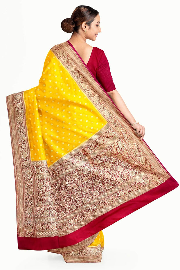 Banarasi silk georgette saree  in yellow with small motifs all over the body.