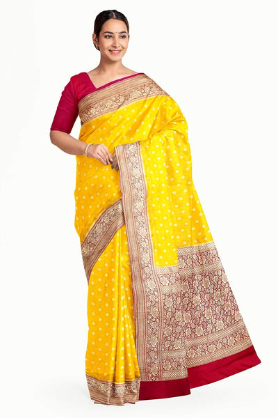 Banarasi silk georgette saree  in yellow with small motifs all over the body.