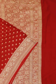 Banarasi silk georgette saree  in red with small motifs all over the body.