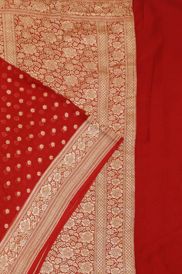 Banarasi silk georgette saree  in red with small motifs all over the body.